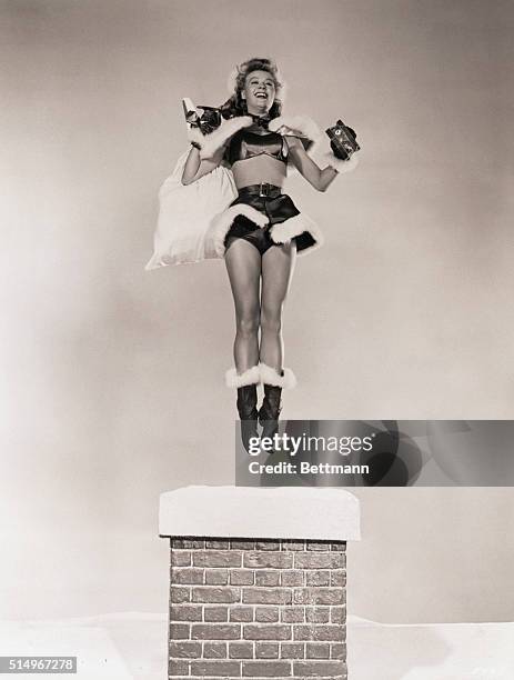 Hollywood, CA- Blonde dancing star, Vera Ellen, is shown happily getting ready to impersonate Santa CLaus come Christmas Eve, as she makes a practice...