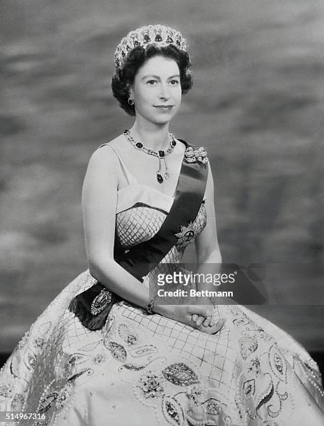 In a white satin evening gown embroidered in gold and pearls, Queen Elizabeth is shown in this royal command portrait. She wears the Rib and Star of...