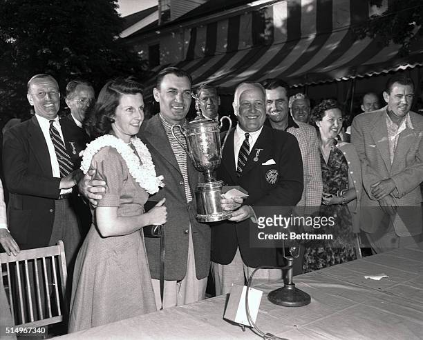 Comeback champion Ben Hogan, of Fort Worth, Texas, and his wife, Valerie, are shown with the trophy Hogan won after they beat Lloyd Mangrum and...