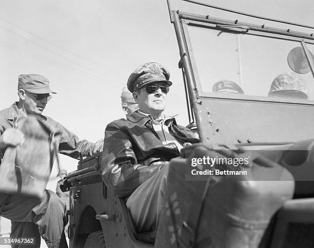 Korea-ORIGINAL CAPTION READS: Grim-faced General Douglas MacArthur is shown in a jeep as he toured the fighting front in Korea, after the invasion of...
