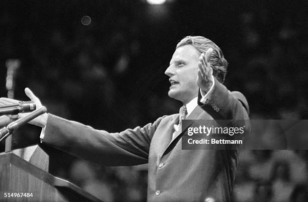 Evangelist Billy Graham, arms thrown wide, addresses revival meeting held in Madison Square Garden May 15th. This is the first of a series of...