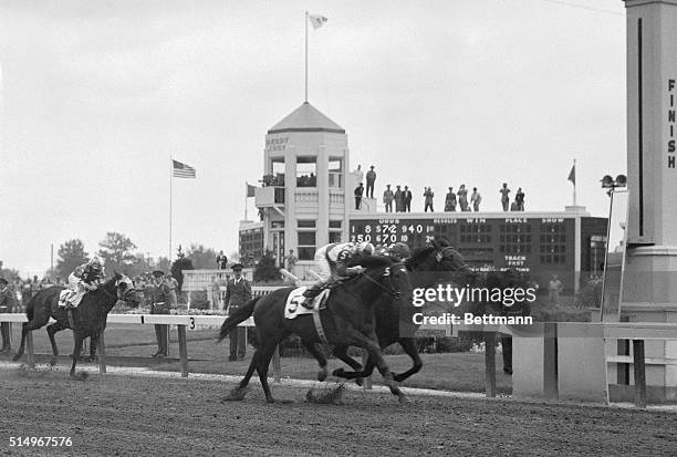 Racing towards the wire in a pulse-pounding finish, Iron Liege , with Willie Hartack up, nips Gallant Man , ridden by Willie Shoemaker, to win the...