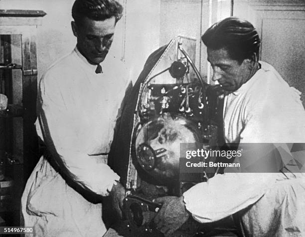 Soviet scientists check the chamber aloft in a test flight preparatory to launching the Sputnik 11. Launched November 3rd, Sputnik 11 carried a...