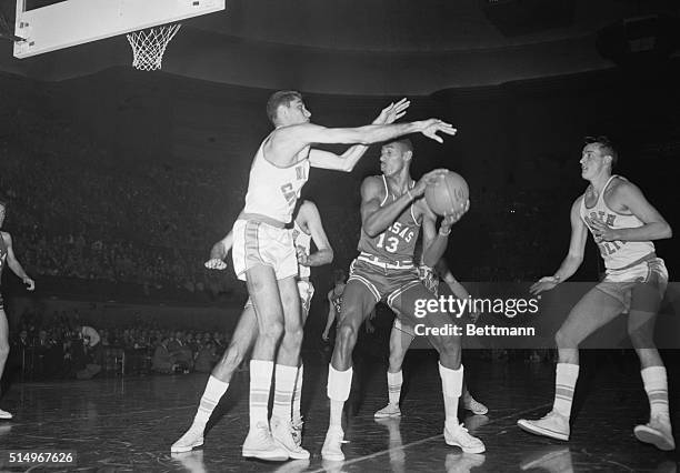 Titans Battle. Kansas City, Kans.: All American Lennie Rosenbluth , of North Carolina, sets up a block on All-American Wilt Chamberlain, of Kansas,...