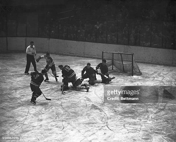 Montreal Canadiens' Maurice Richard slips to the ice during a scrimmage in tonight's game with the New York Rangers, who won the first game of the...