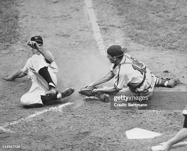 Tookie Gilbert of the New York Giants tries to steal home in the seventh inning of the second game of a doubleheader with the St. Louis Cardinals at...