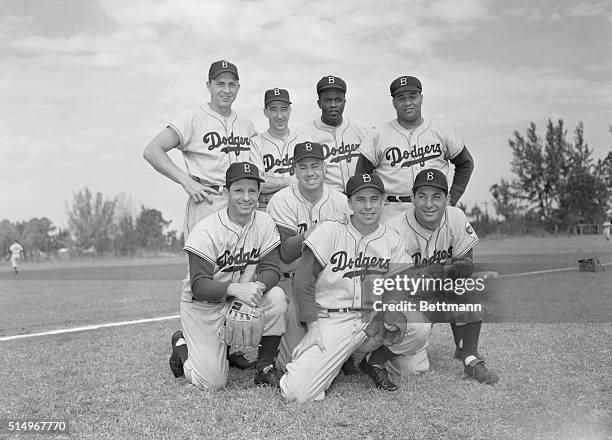 Members of the Brooklyn Dodgers team for 1952 happily take time out from rigorous spring training to pose for the camera. Left to right are...