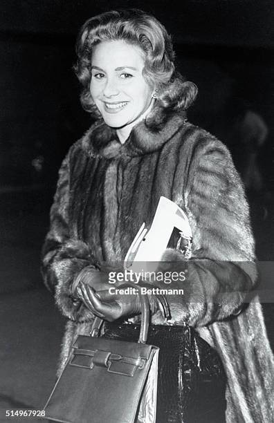 Athina Onassis, the attractive wife of millionaire Greek ship owner Aristotle, arrives at London Airport, well muffled in a fur coat, from Paris. She...