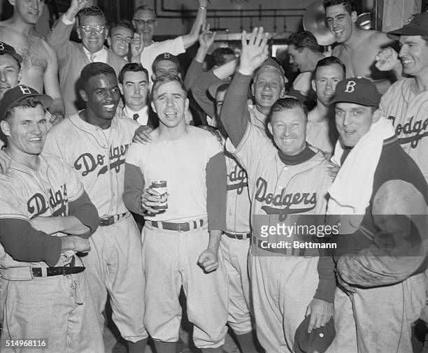 Members of the Brooklyn Dodgers smiled happily, and shouted for joy, in their dressing room after defeating the Philadelphia Phillies 9-8, to tie...