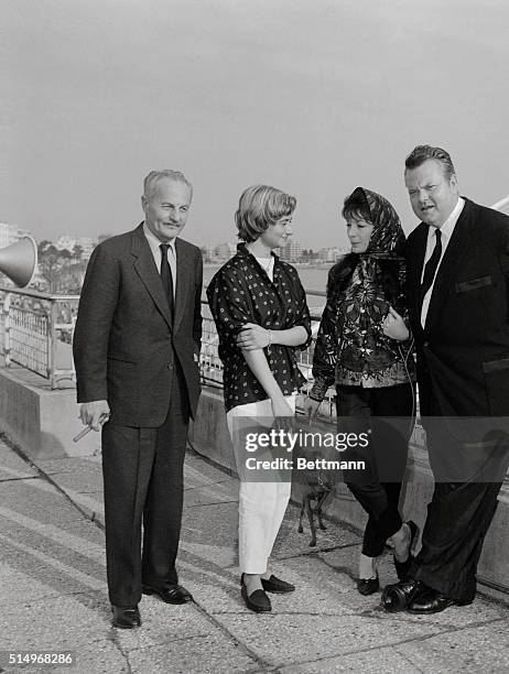 Getting together in Cannes, France, are producer Darryl F. Zanuck, French author Francoise Sagan, French singer-actress Juliette Greco, and...