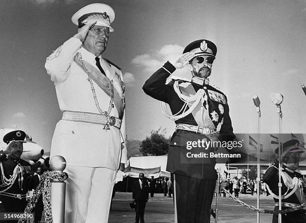 Addis Ababa, Ethiopia: Greets and Salutations. Standing on a raised reviewing stand, Yugoslavia's President Tito, and Ethiopian Emperor Haile...