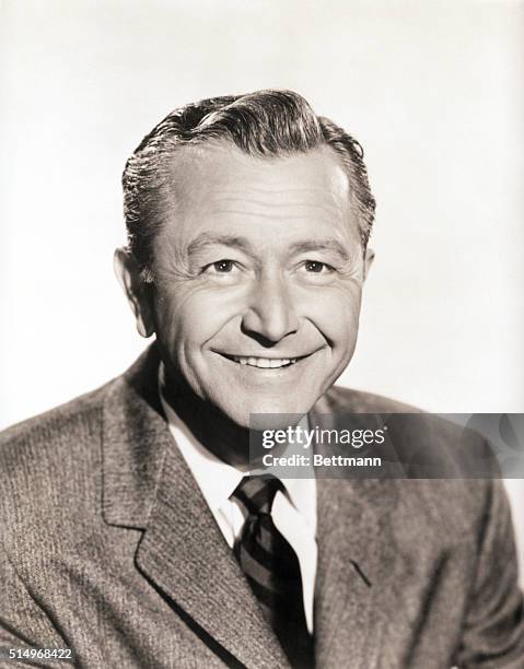 Head and shoulders photo portrait of movie and television actor Robert Young smiling broadly.