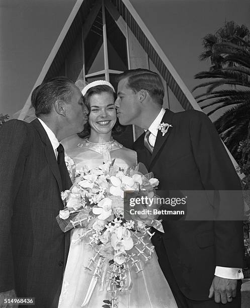 Mrs. Robert Brown , the former Sharon Mae Disney, receives two kisses here after her marriage. Kissing on the left is her father, cartoonist Walt...