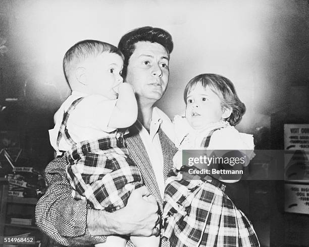 Hollywood: Eddie Fisher holds his two children, Todd 1, and Carrie , while shopping for toys just before his departure for Las Vegas and a possible...