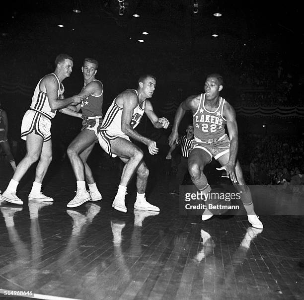 Minneapolis Lakers' Elgin Baylor moves in for another tally in 1st quarter action here 11/10 night against St. Louis Hawks. Baylor recently set NBA...
