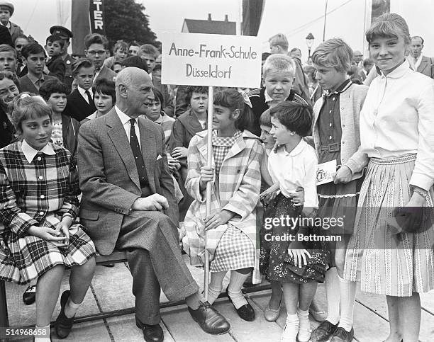 Otto Frank seated with schoolchildren of the "Anne Frank School" during cornerstone laying ceremony at Wyppeltal.