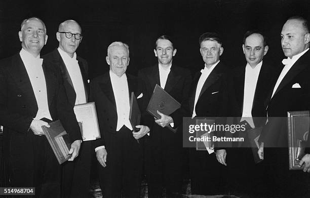 Seven recipients of this year's Nobel Prize awards are pictured after ceremonies at the Stockholm Concert Hall. : Dr. George Beadle & Dr. Edward L....