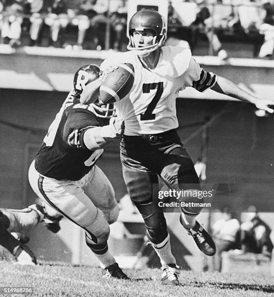 Toronto Argonauts quarterback Joe Theismann under the close pursuit of Ottawa's defensive tackle Rudi Sims, in a game played here today. The...