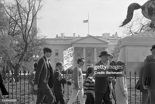 The flag on the White House flies at half mast in mourning for Dr. Martin Luther King today as students from Georgetown University march in Lafayette...