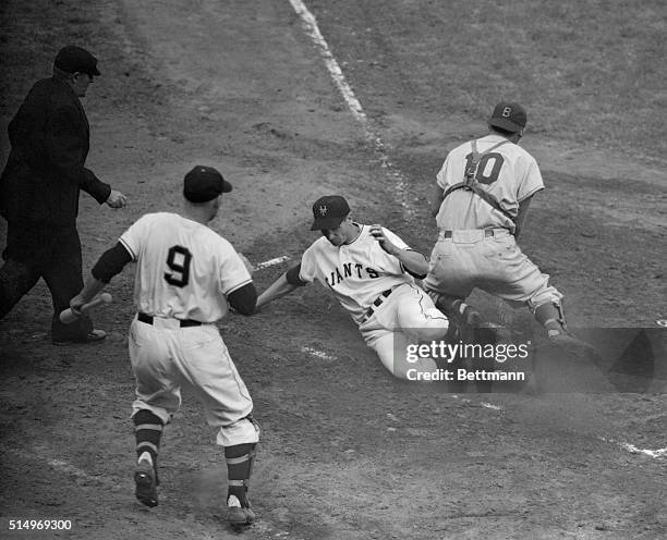 Bobby Thomson of the New York Giants is safe at home plate in the first inning of the second game of the Giants-Dodgers double header at the second...
