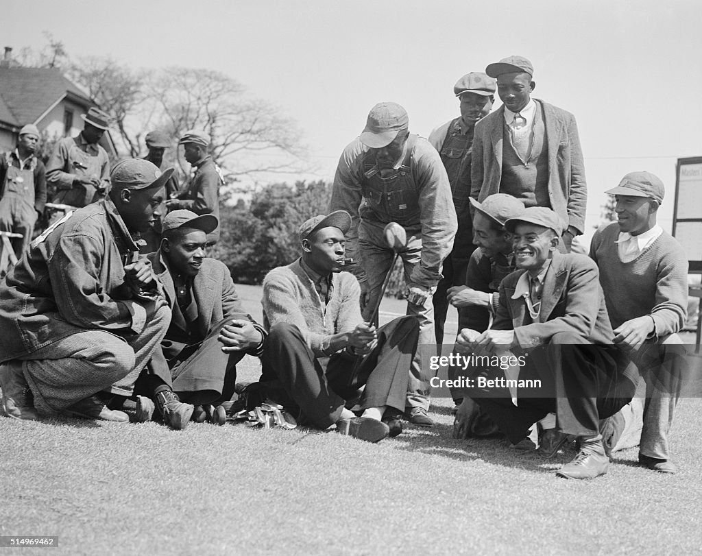 Caddies Sitting on the Green