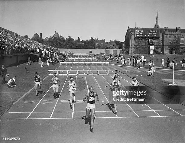 Jesse Owens of Ohio State winning the 220-yard low hurdles event in the NCAA meet in Chicago. Don Elser of Notre Dame is second, and Ben Willis of...