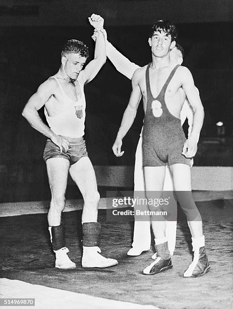 Wrestler B.S. Jernigan of the United States is shown being declared winner of the elimination match at the London Olympics as his opponent M. Raissi...