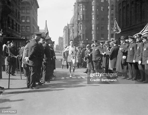 Canadian runner wins Boston Marathon, and sets new record...Johnny Miles, of Hamilton, Ontario, Canada, won the Boston A.A. Marathon, doing the 26...