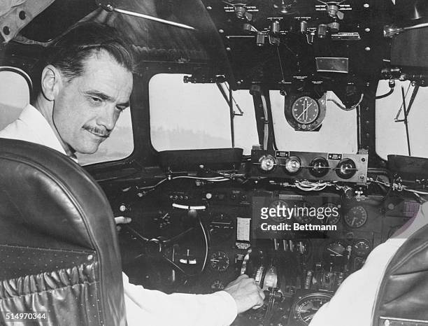 Plane maker Howard Hughes at controls of a TWA Constellation demonstrates $130 radar warning system to be available for airline planes. Dials on...