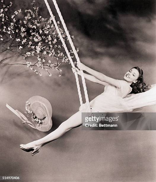 Actress Joan Leslie is to star in the movie "Janie Gets Married." She is shown swinging on a swing.