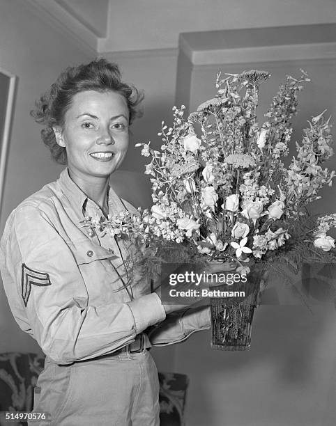 Pictured at the Hotel Lexington, New York, where she is resting after her trip from the West Coast, Corporal Margaret Hastings of Owego, NY, a...