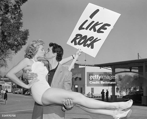 Actor Rock Hudson gets a kiss from his shapely "campaign manager" Kathleen Hughes, as he campaigns for mayor of Universal City, home of...