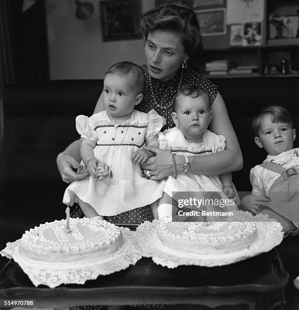 Rome, Italy: Holding Isabella and Isotta on her lap, famed Swedish-born film star Ingrid Bergman Rossellini helps her twins celebrate their first...