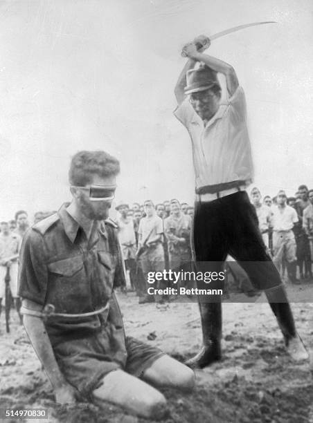 Japanese officer, with raised sword, prepares to execute an Australian Aircorps prisoner of war in Japanese held territory during World War II.