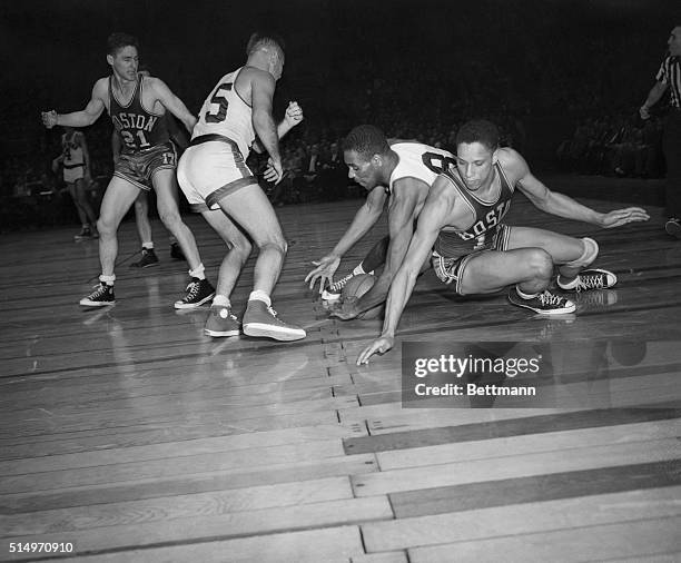 Nat Clifton , of the Knickerbockers, and Chuck Cooper, of the Boston Celtics, vie for the ball in the third-quarter action of the pro basketball tilt...