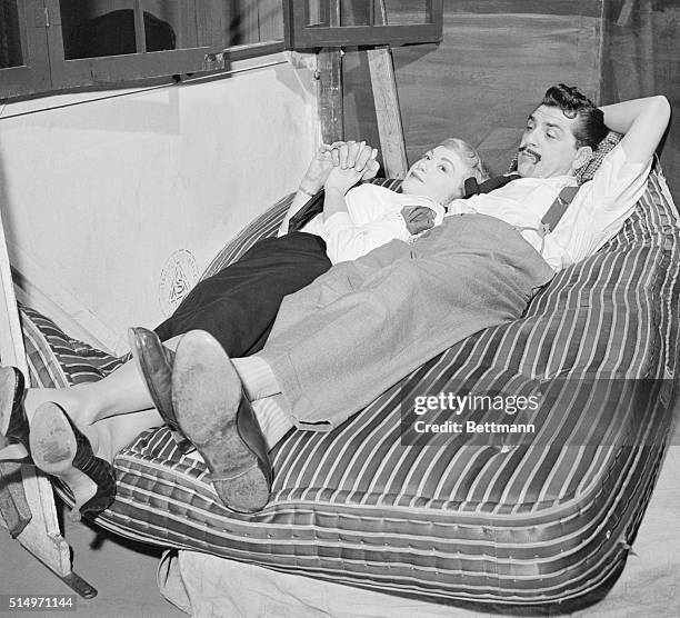 Comedian Ernie Kovacs, DuMont TV star, and his new bride, singer Edith Adams, relax together on a mattress used on his show to break his fall from a...