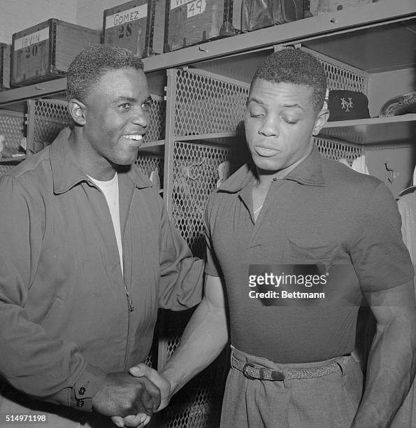 With a "Oh, it was nothing" expression, Willie Mays, , fleet, young outfielder of the New York Giants, accepts the congratulations of Brooklyn Dodger...