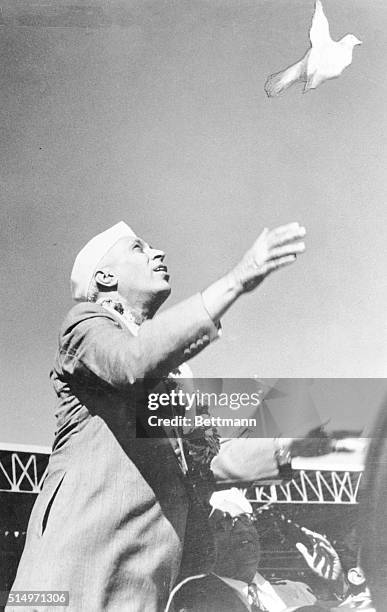 Prime Minister Jawaharlal Nehru, who recently celebrated his 66th birthday, releases a white pigeon, symbolic of peace, at festivities in New Delhi....