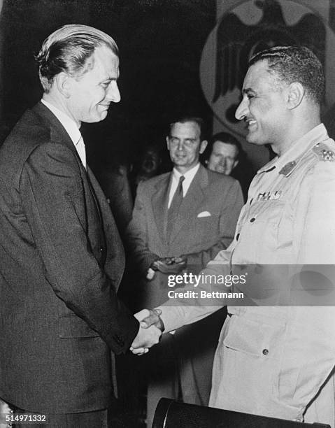 Egyptian Prime Minister Abdel Nasser shakes hands with British Minister of State Anthony Nutting after the two men signed the Anglo-Egyptian Suez...