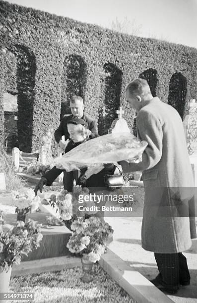 Flowers are placed on the graves of the Drummond family-- Sir Jack, Lady Anne, and daughter Elizabeth-- byt friends at a cemetery in forcalquier,...