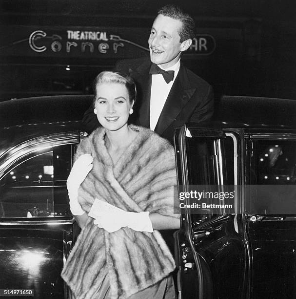 Lovely actress Grace Kelly, escorted by dashing Oleg Cassini, former husband of Gene Tierney, arrives for the glittering premiere of the movie...