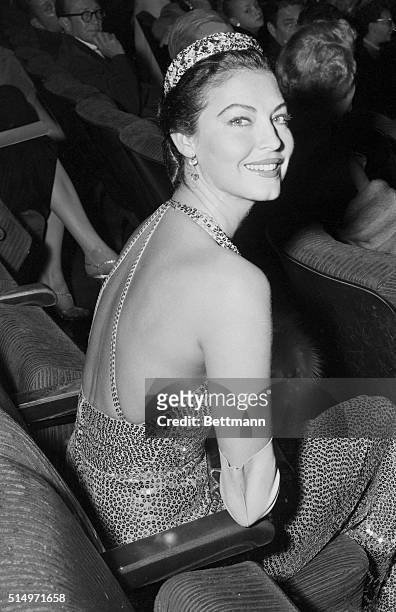 This view shows off a striking gown as well as film actress Ava Gardener, attending the premiere of The Barefoot Contessa, in which she stars. She...