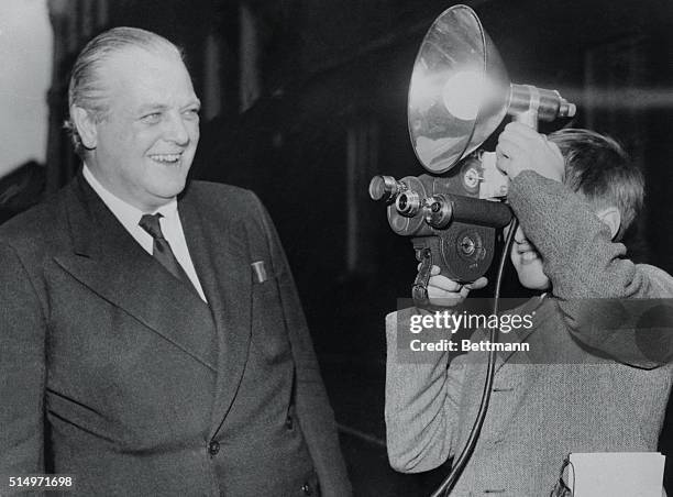 Thirteen-year-old Winston Churchill, grandson of the British Prime Minister, uses a camera borrowed from a photographer to take pictures of his...