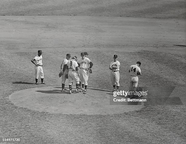 While catcher Wes Westrum stirs up the dirt at the mound, and shortstop Alvin Dark stares suspiciously over his shoulder, pitcher Sal Maglie looks...