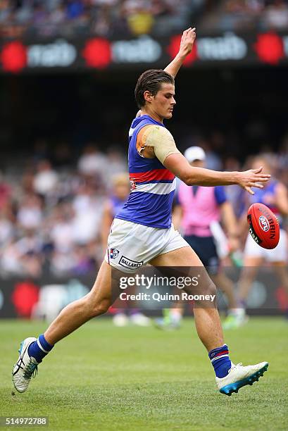 Tom Boyd of the Bulldogs kicks during the 2016 NAB Challenge AFL match between the Collingwood Magpies and the Western Bulldogs at Etihad Stadium on...