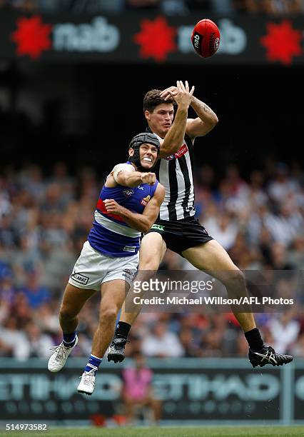 Jack Crisp of the Magpies and Caleb Daniel of the Bulldogs compete for the ball during the 2016 NAB Challenge match between the Collingwood Magpies...