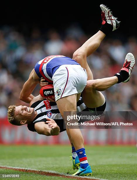 Koby Stevens of the Bulldogs is tackled by Adam Treloar of the Magpies during the 2016 NAB Challenge match between the Collingwood Magpies and the...