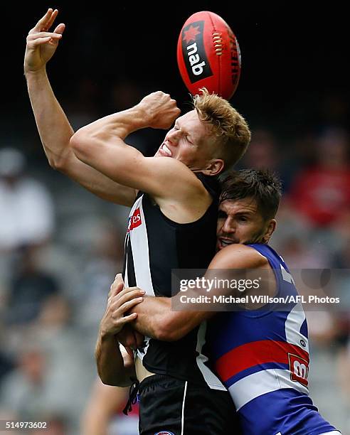 Adam Treloar of the Magpies is tackled by Koby Stevens of the Bulldogs during the 2016 NAB Challenge match between the Collingwood Magpies and the...