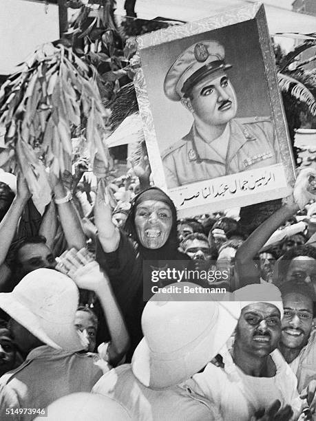 Cairo, Egypt- A native woman leads a group of cheering demonstraters in front of the President to hail, Gamal Abdel Nasserm upon his election as...