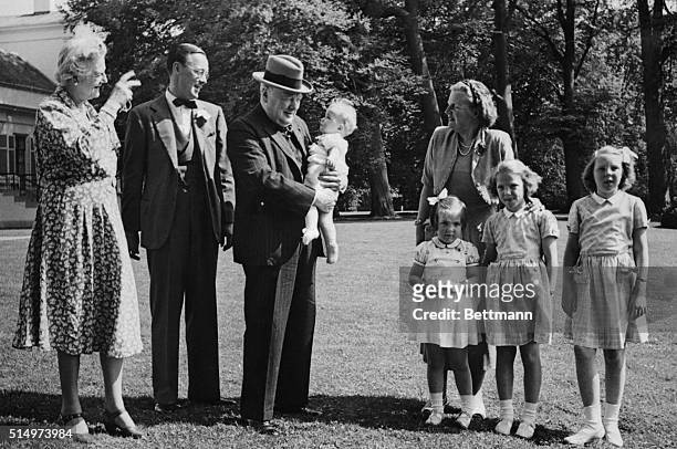 British former Prime Minister Winston Churchill holds his goddaughter Marijke in the grounds of Soestdijk Palace, during a visit to the Dutch Royal...